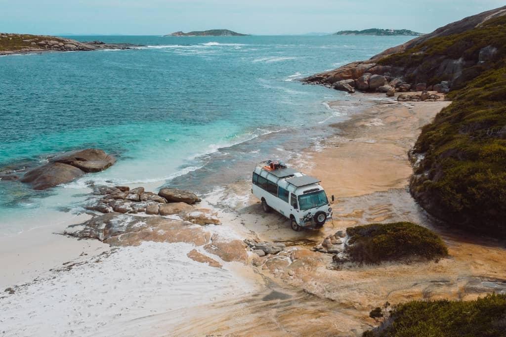 Caravan parked next to the water, on the rocks of Wharton Beach, Esperance, Western Australia