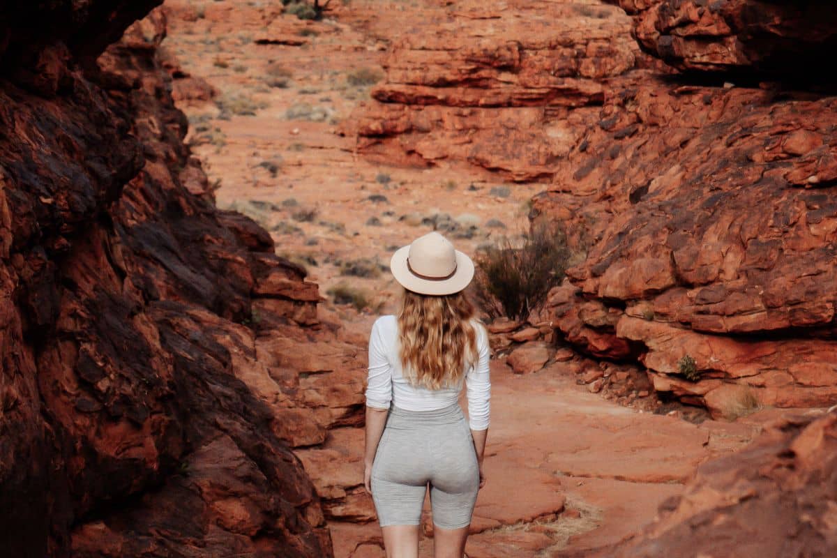 Woman standing on rock looking out into the gorge. One of the best parts of hiking in the NT.