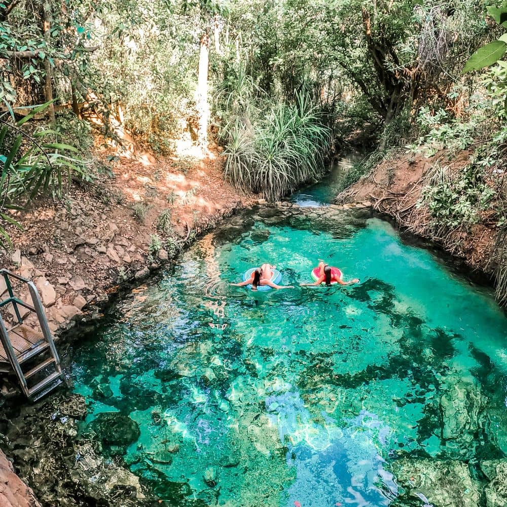 Two women on inflatable rings floating in the Katherine Hot Springs. The unforgettable Katherine Hot Springs are able to energize your body, soul and mind. This is the very popular swimming hole at Katherine Springs.
