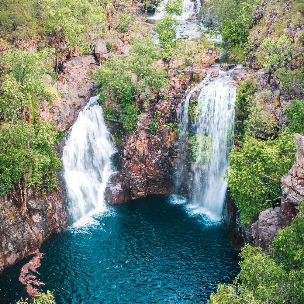 Establishing shot of a beautiful waterfall surrounded by greenery. One of Litchfield national parks best waterfalls: Florence Falls.