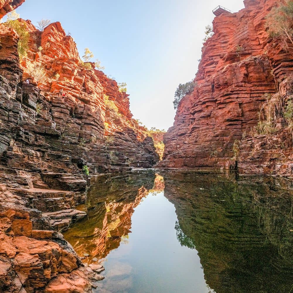 Rock formation reflecting off of the completely still water beneath it. Joffre gorge has everything, including a pool, all in the middle of nowhere. This is the pool at the bottom of Joffre Gorge in Karijini, Western Australia.
