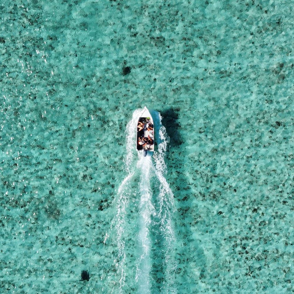 Boating in Exmouth, Western Australia. 4 people in a boat on the reef.