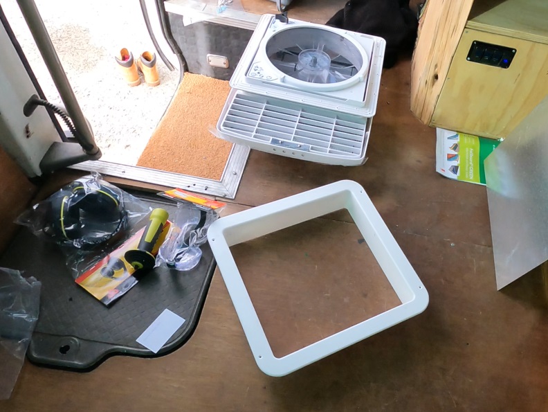 All parts of the MaxxxAir fan. On the floor of the Toyota Coaster. Getting ready for install