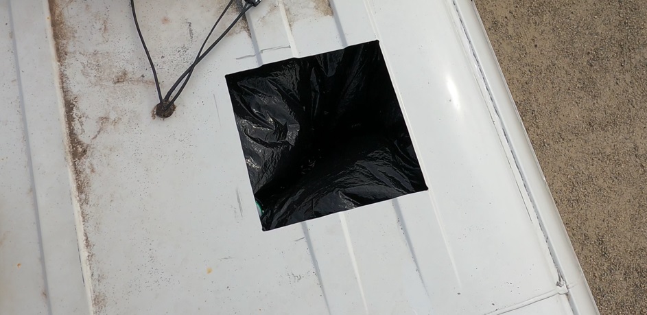 Adding a plastic bag underneath the cut for the MaxxAir Fan. 