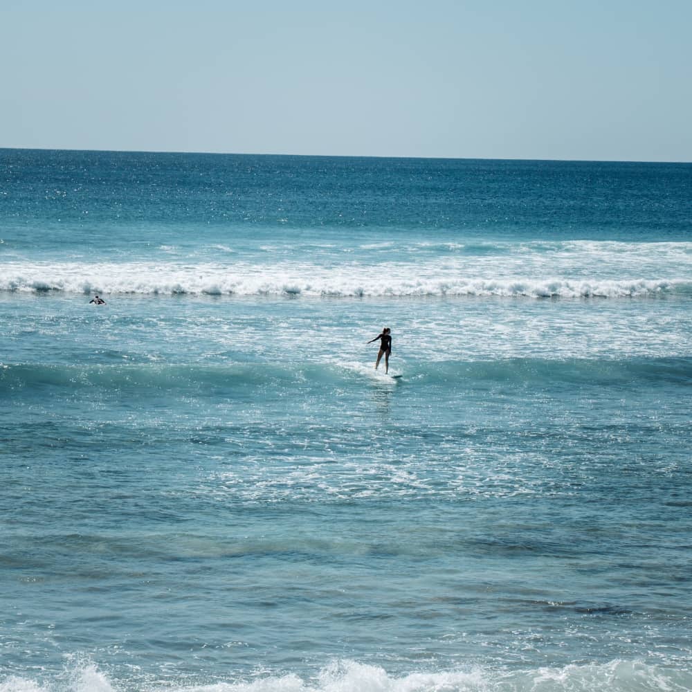 girl surfing hunters beach exmouth
