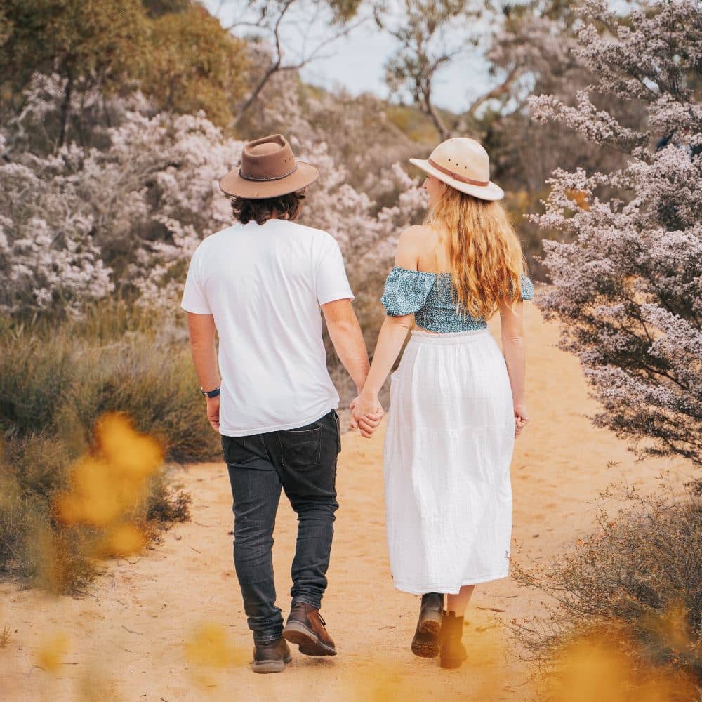 Wildflower season in Kalbarri, WA. A couple walking around viewing flowers in Western Australia