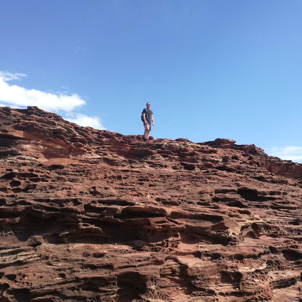 hiking kalbarri island rock and natural bridge view of man walking on large rock in kalbarri