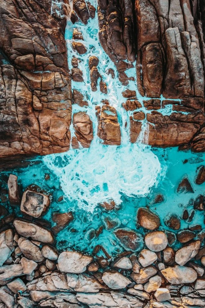 Injidup Spa tourist attraction. View from a drone looking down on the natural sea waterfall.