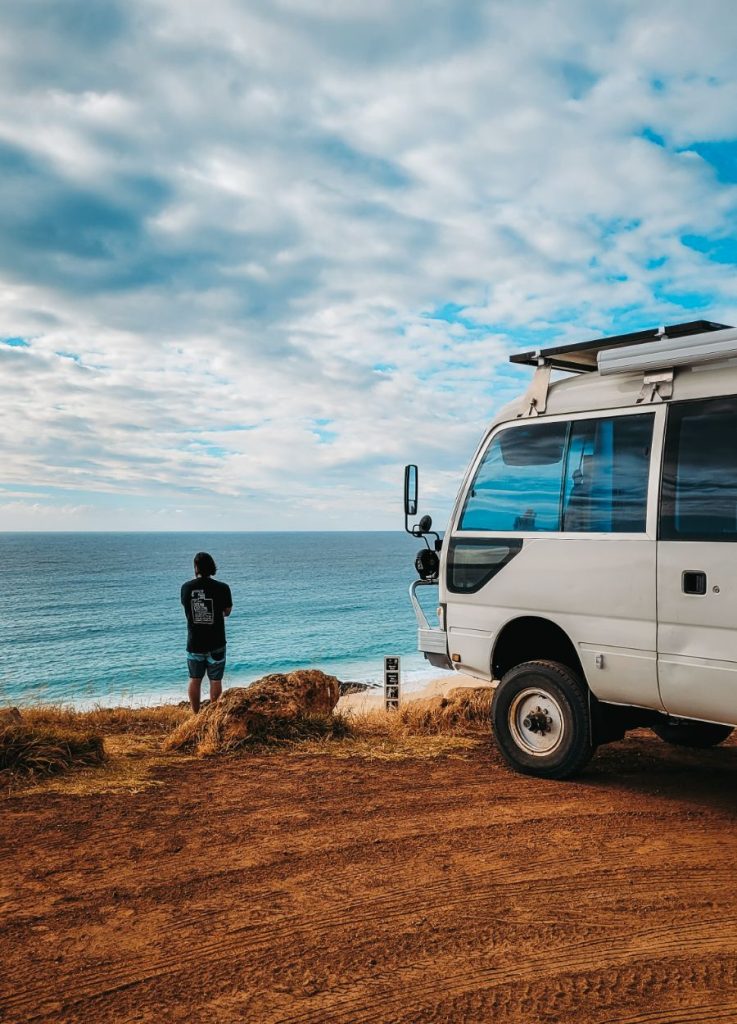 Onilne working in Australia. Can be lonely. Chris from Salt and Charcoal looking over water with a bus in foreground.