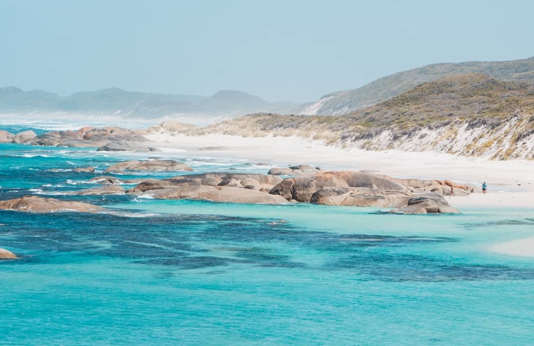 a view of Greens Pool Western Australia with turquoise water and, rock formations, white sand shore