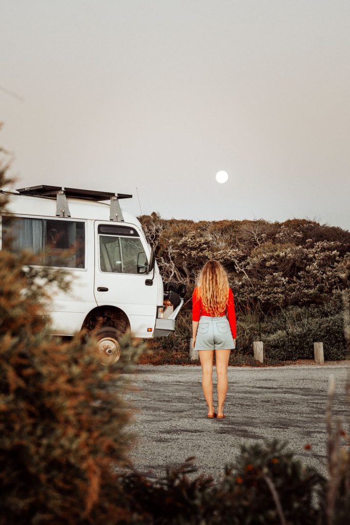 Beck standing by the Salt and Charcoal van gazes at the moonrise over Granny's Pool in Augusta, Western Australia,