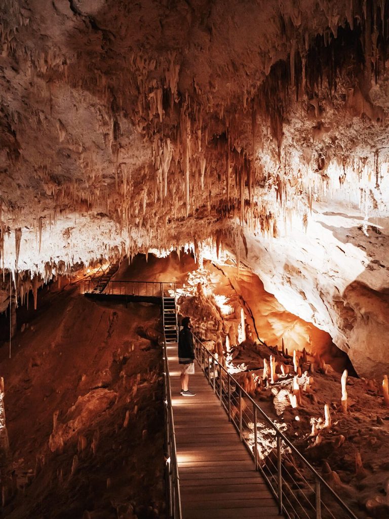 Man watching Margaret River's Underground Cave stalactites and stalagmites in Western Australia