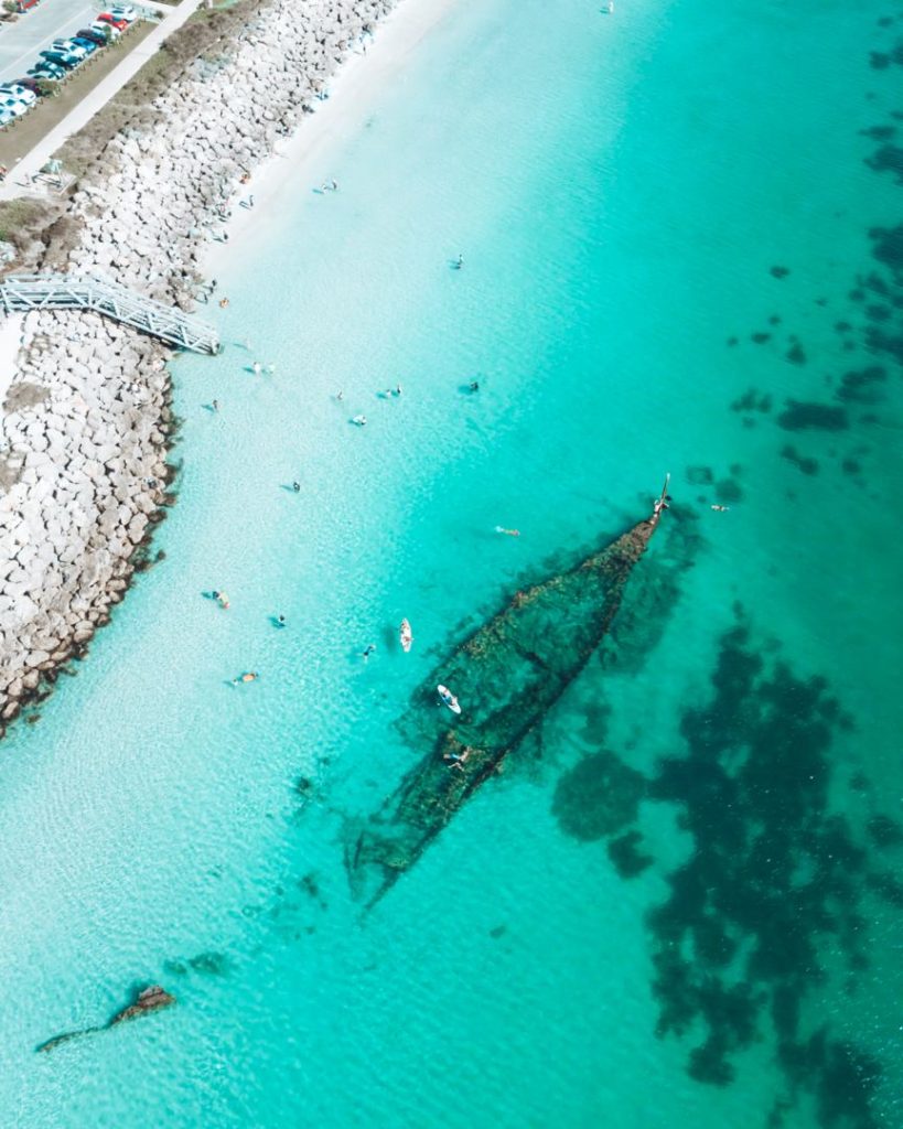 Aerial view of the Omeo shipwreck off the coast of Perth, Western Australia, submerged in clear turquoise waters.