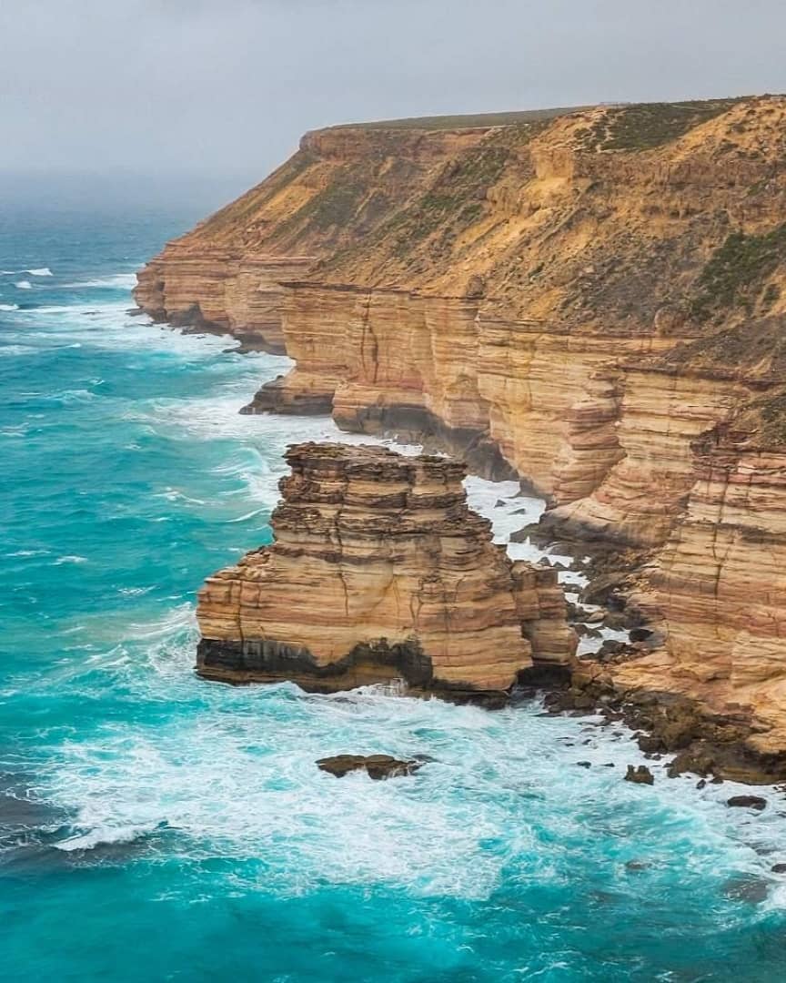 Aerial view of the rugged coastal cliffs and turquoise waters along the Bigurda Trail, featuring Island Rock in Kalbarri, Western Australia.
