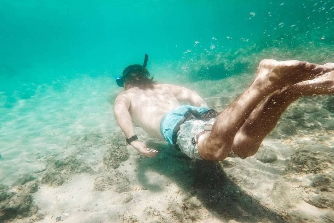 A person snorkeling underwater at Blue Holes in Kalbarri, Western Australia.