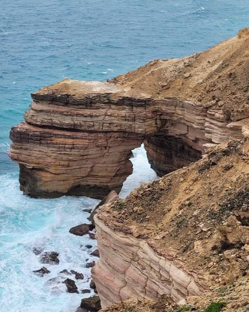 Natural Bridge in Kalbarri, Western Australia, with waves crashing against the rocky arch formation.