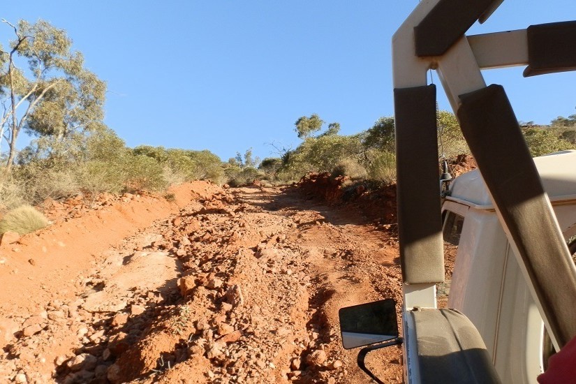 A rugged dirt track winding up the Ridge-top Road, showcasing the challenging terrain and natural beauty of Arkaroola Wilderness Sanctuary in South Australia.
