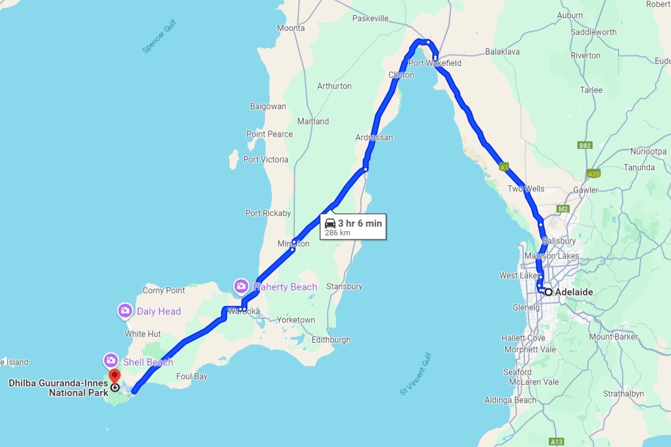 Map with a route highlighted in blue, starting from Adelaide and ending at Dhilba Guuranda-Innes National Park. The route covers a distance of 286 kilometers, with an estimated travel time of 3 hours and 6 minutes. Notable stops along the way include locations like Ardrossan, Clinton, and Port Rickaby. The map highlights various coastal areas and landmarks along the Yorke Peninsula in South Australia.