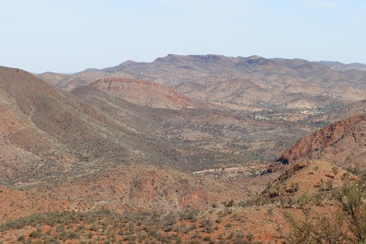 A panoramic view of Arkaroola Village nestled among the rugged hills as seen from Coulthard Lookout in South Australia, illustrating the remote beauty of the Arkaroola Wilderness Sanctuary.