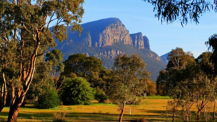 Mount Abrupt viewed from Dunkeld, Victoria, with trees and a pond in the foreground during the Mount Abrupt walk.