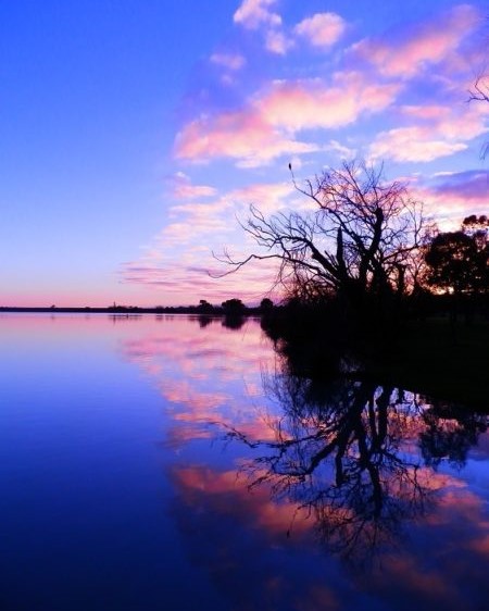 Sunrise over Lake Cullulleraine with pink clouds reflecting on the calm water, perfect for things to do at Lake Cullulleraine.