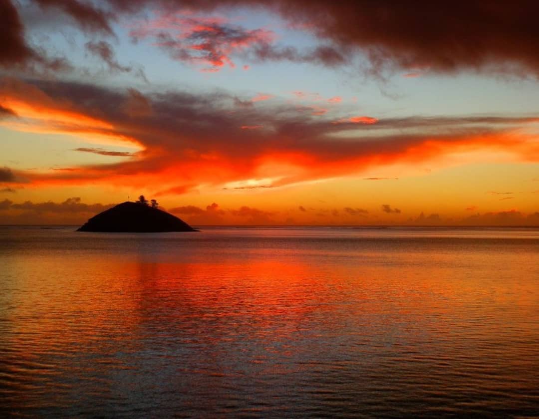 A vibrant sunset over Blackburn Island, viewed from Lord Howe Island in New South Wales.