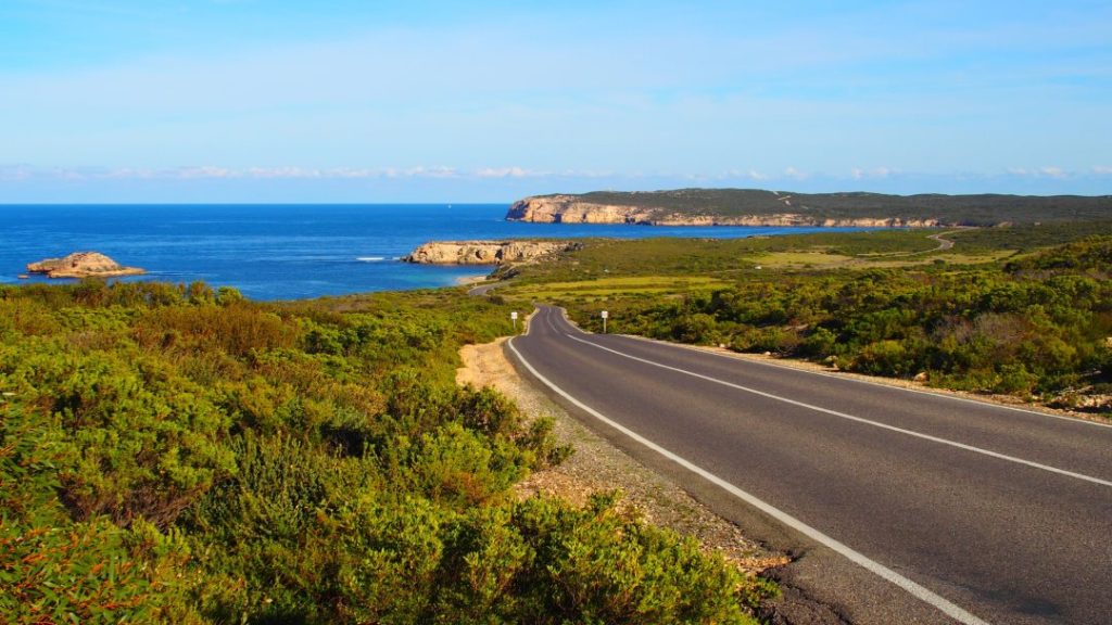 The scenic road leading to Dhilba Guuranda-Innes National Park on the Yorke Peninsula, South Australia, offering views of the ocean, cliffs, and coastal vegetation along the way.
