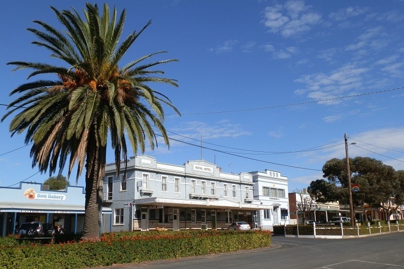 A quiet street in Rainbow, Victoria, featuring the historic Royal Hotel, a tall palm tree, and the Bow Bakery with clear blue skies above, capturing small-town charm.