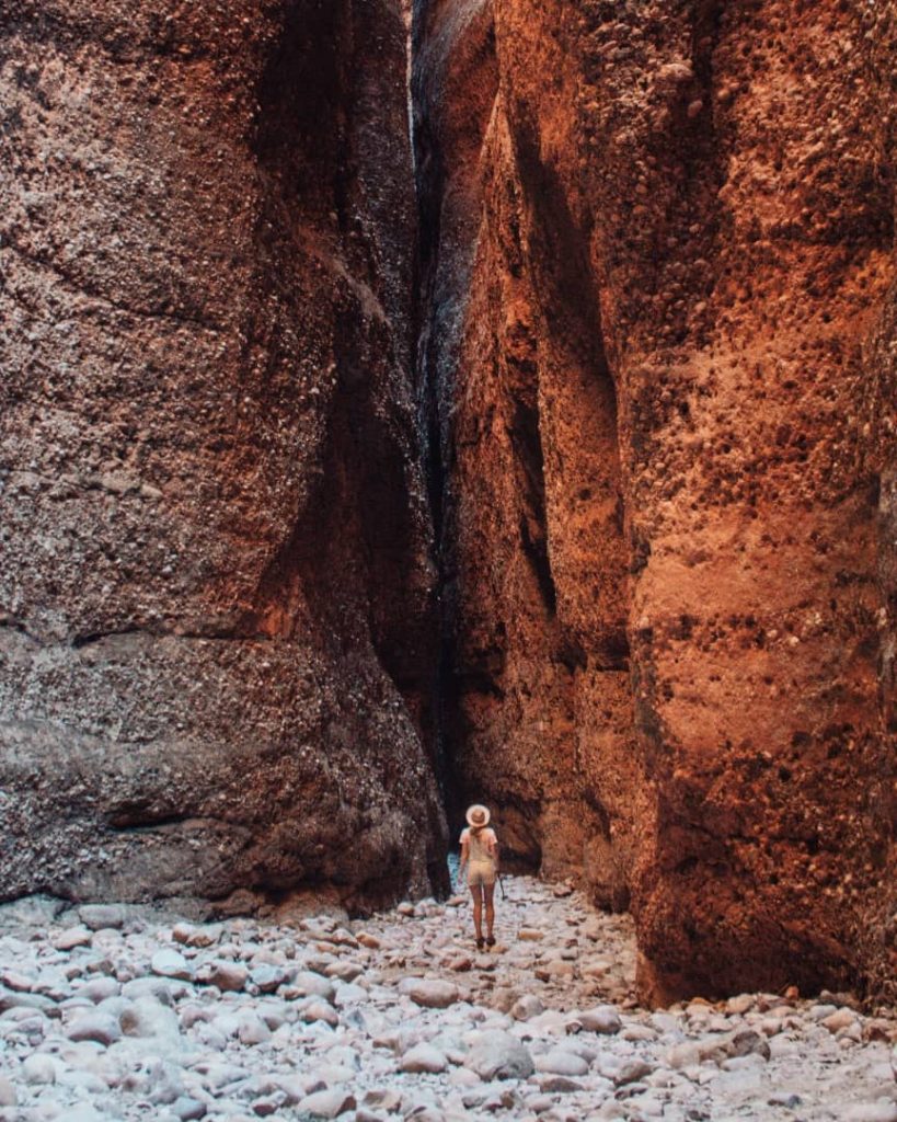 A visitor stands between towering rock formations in Purnululu National Park, home to the Bungle Bungles.