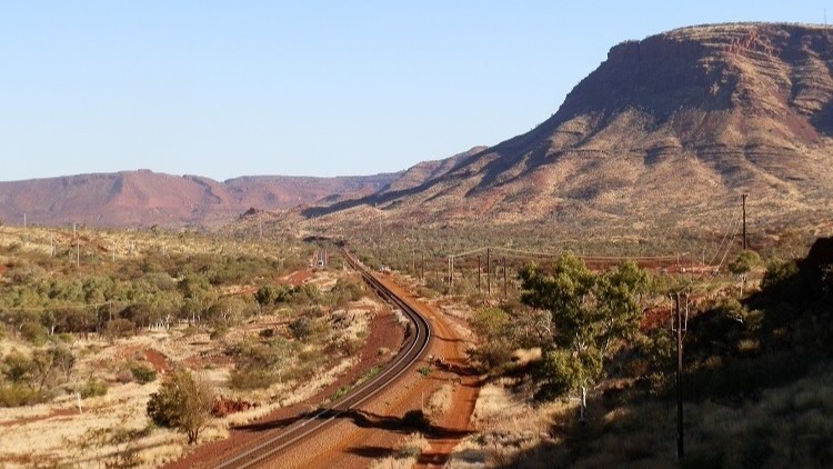 View of Mt Nameless, a popular attraction for things to do in Tom Price, with rugged slopes under a clear sky.