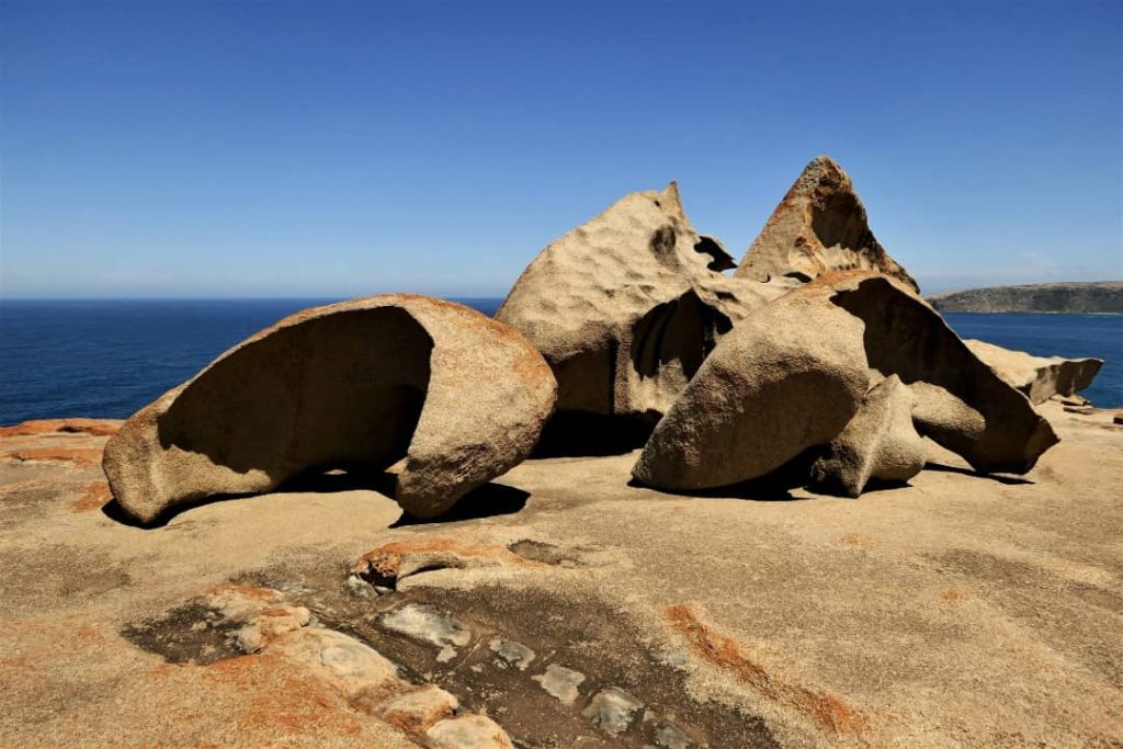 Unique and weathered rock formations at Flinders Chase National Park, set against a clear blue sky and overlooking the ocean on Kangaroo Island.