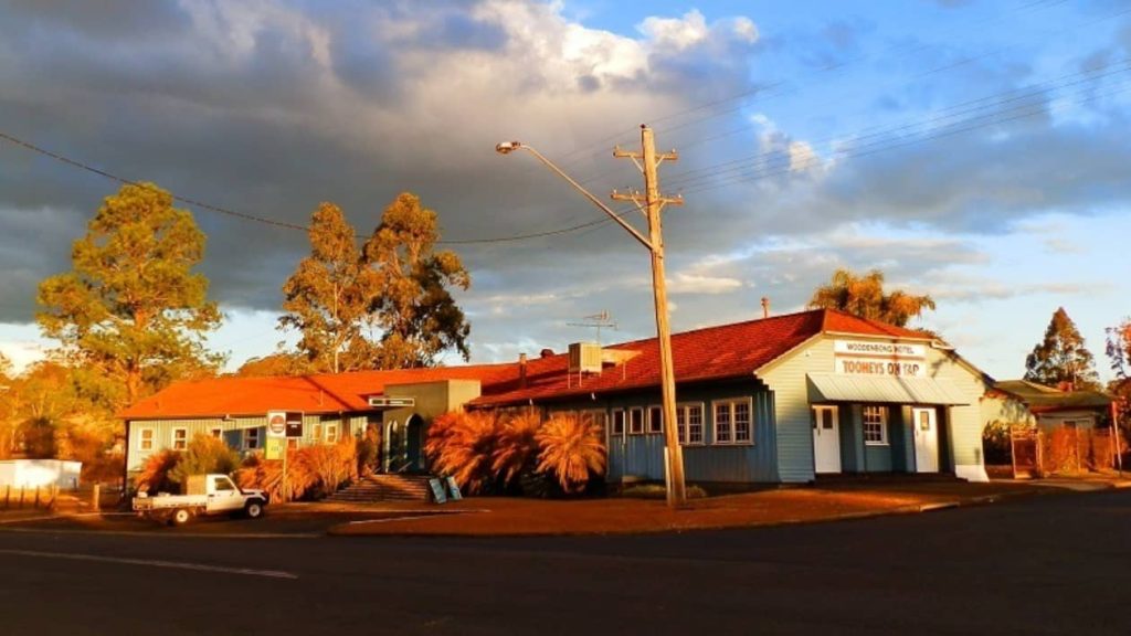 The Woodenbong Hotel in New South Wales, showcasing a classic country pub under a dramatic evening sky.