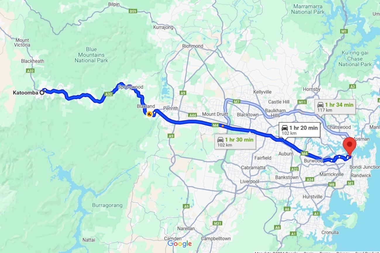 This is a Google Maps screenshot showing a driving route from Katoomba (Blue Mountains) to a destination in Sydney, Australia. The route is highlighted in blue, passing through areas like Springwood, Blaxland, and Penrith before reaching the city. The estimated travel times range from 1 hour 20 minutes to 1 hour 34 minutes, depending on the chosen route.