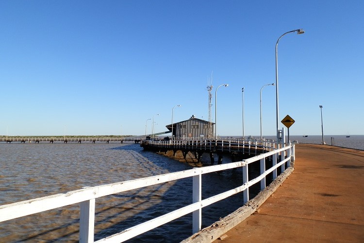 High tide at Derby Jetty with water covering the shoreline and a view of the pier extending into the ocean—an essential experience among things to do in Derby WA.