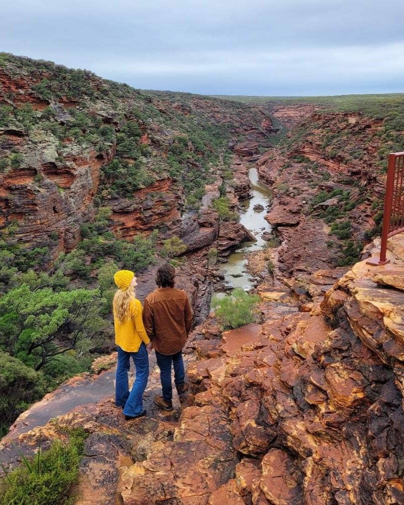 Two hikers gazing into the deep, winding gorge of Z-Bend in Kalbarri National Park.