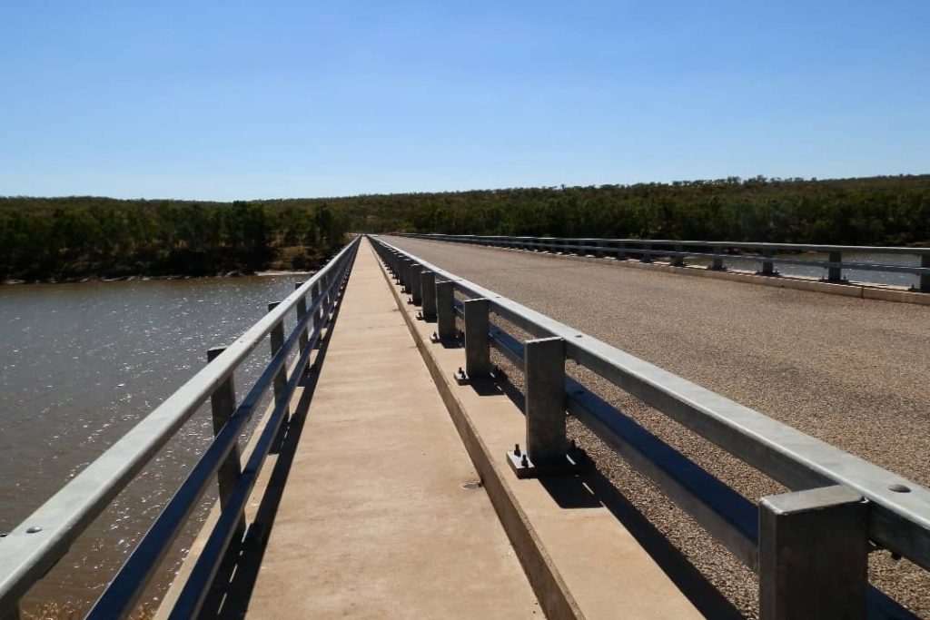 Long, isolated bridge stretching over the Victoria River near Timber Creek, NT, commonly known as the "Bridge to Nowhere."