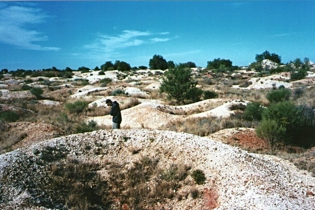 A person exploring the undulating Fossicking Fields in outback New South Wales, known for its opal-rich soil.
