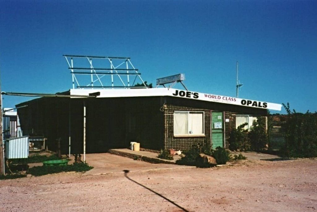 Exterior view of Joe’s World Class Opals shop, known as the "Stubby House," in White Cliffs, NSW, with a rustic outback style.