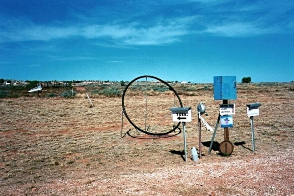A unique view of the White Cliffs Golf Course in NSW, featuring simple equipment and arid landscape, capturing the unconventional charm of outback golfing.