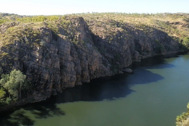 A view of the dramatic cliffs of Katherine Gorge reflected in the still waters of the river below.