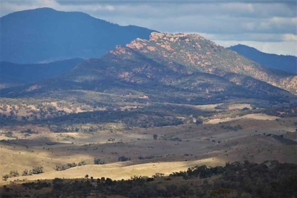 Scenic view of Devils Peak and Mt Brown in the distance, framed by rolling hills and expansive plains on the Dutchman’s Stern hike in South Australia.