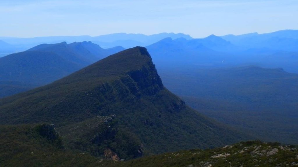 View of Mt Abrupt in the Southern Grampians, with its steep slopes and forested base stretching into the horizon.