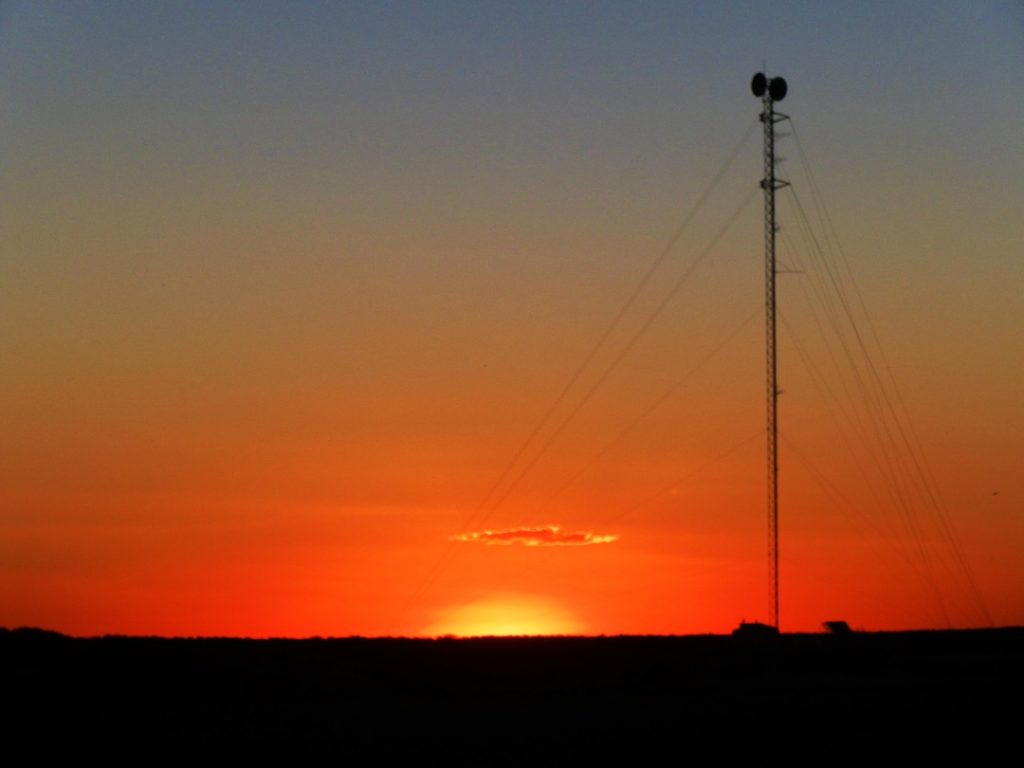 A golden sunset over the expansive outback plains at Cadney Park in South Australia, Australia.