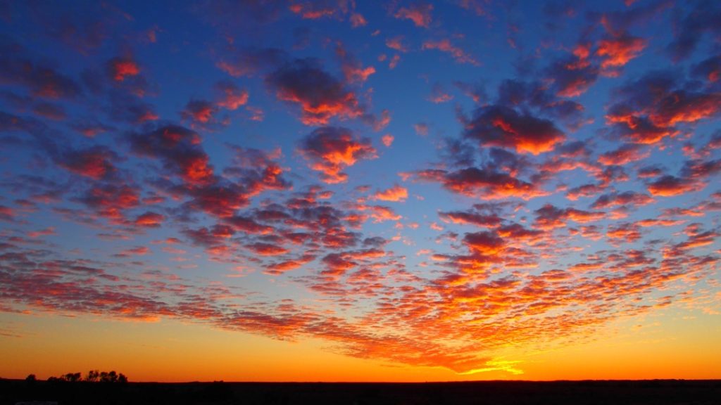 A rustic outback sunset at Farina Station Campground in South Australia, Australia, with glowing skies and rolling plains.