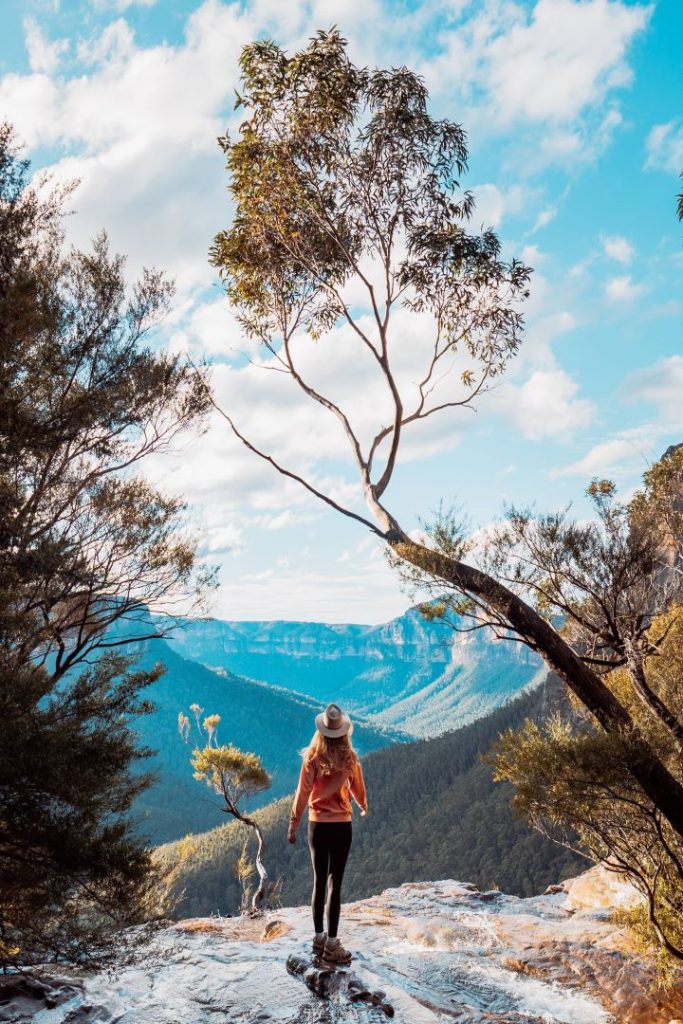 A serene view of Fortress Falls cascading into a rocky basin in the Blue Mountains. The second best time to visit is in autumn for vibrant landscapes and mild temperatures that enhance the experience.