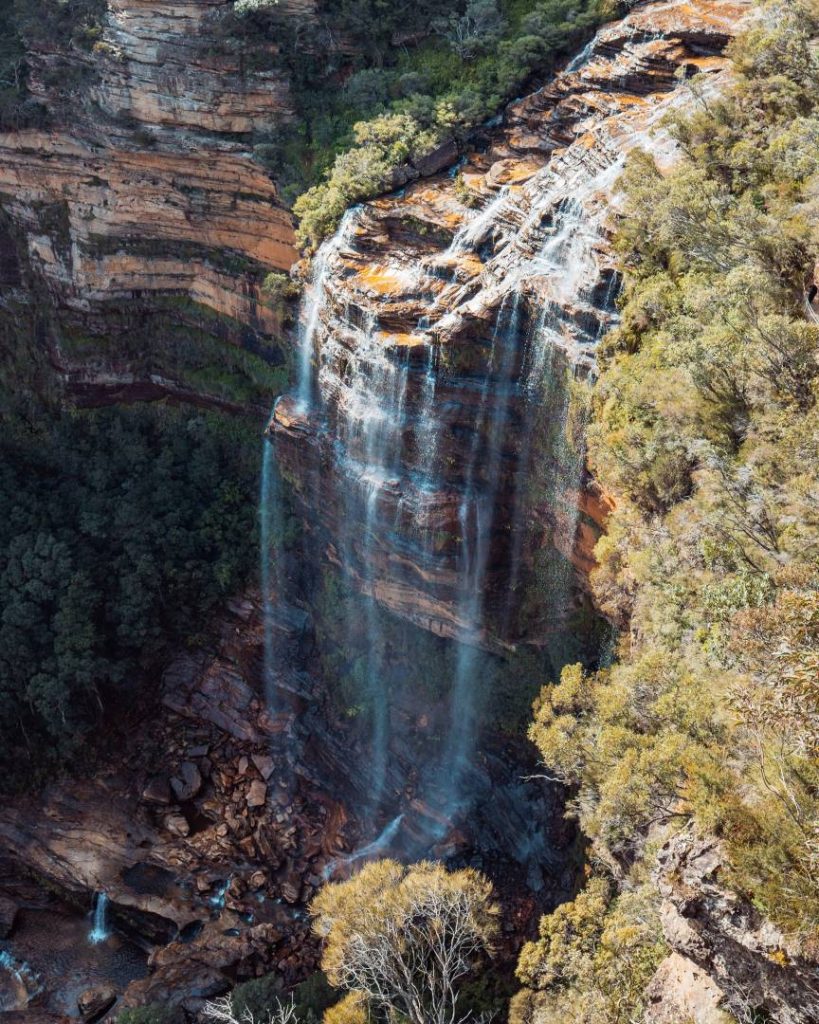 The majestic Wentworth Falls cascading down a steep cliff face in the Blue Mountains, a must-visit stop on the best Blue Mountains tours. The surrounding bushland enhances its beauty