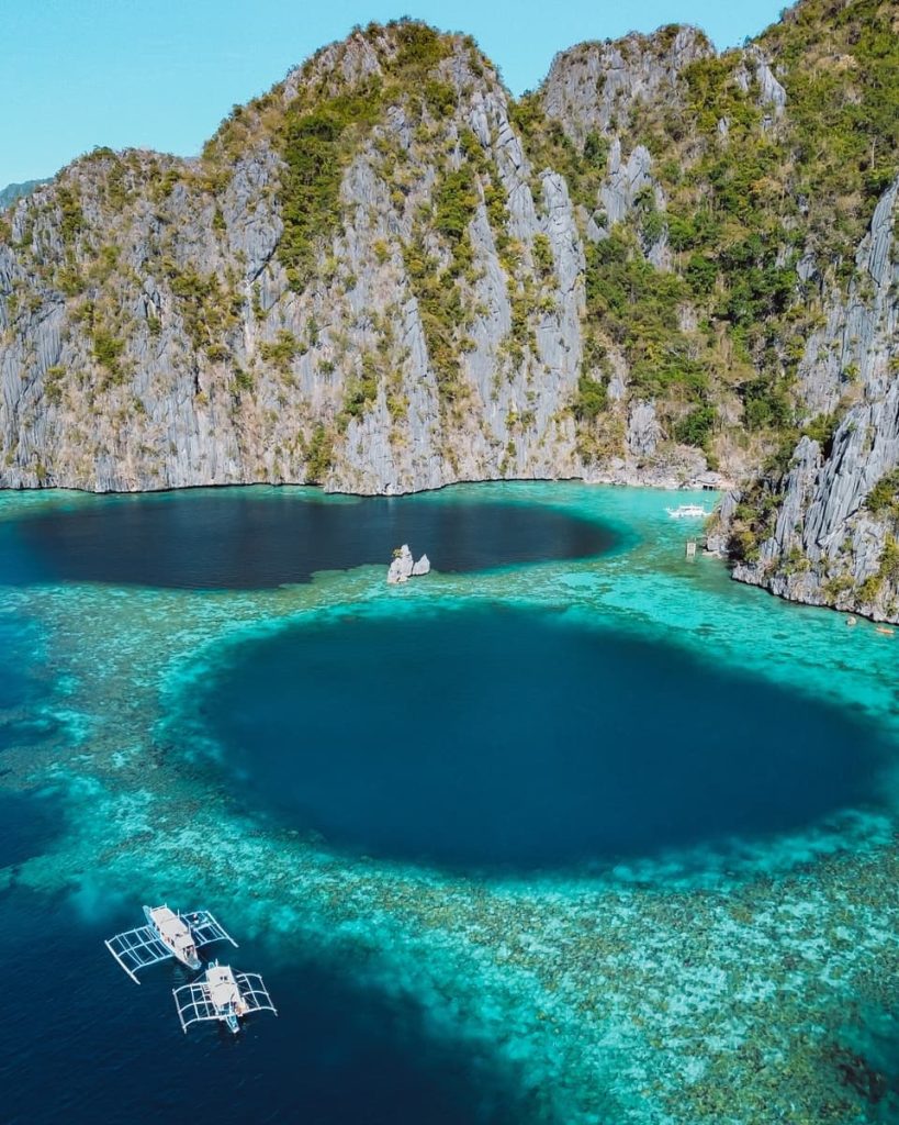 Aerial view of the Twin Lagoon in Coron, with turquoise waters, limestone cliffs, and small boats—one of the most scenic stops on the best tours in Coron, Philippines.