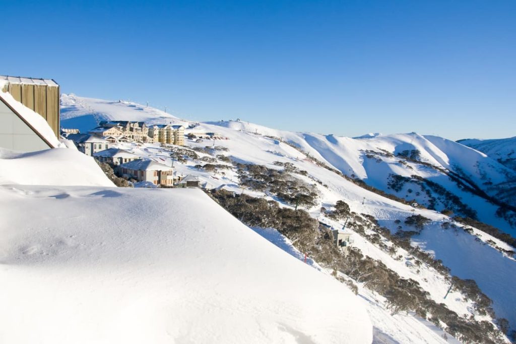 Snow-covered chalets and slopes at Mt Hotham in Victoria’s high country, a winter escape that adds alpine flair to road trips in Australia.