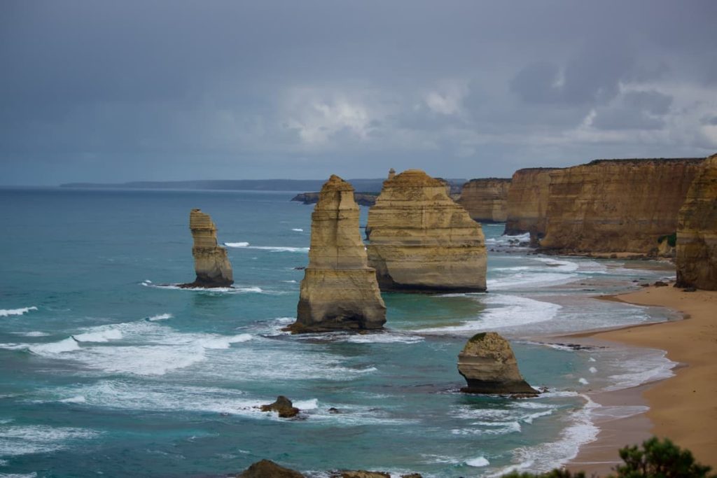 The limestone stacks of the Twelve Apostles rise from the Southern Ocean along Victoria’s Great Ocean Road, a must-see on coastal road trips in Australia.