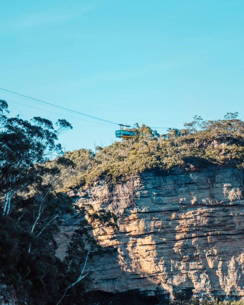 A Scenic Skyway cable car glides over forested cliffs at Scenic World, offering sweeping views across the Blue Mountains—a top experience on any weekend itinerary.